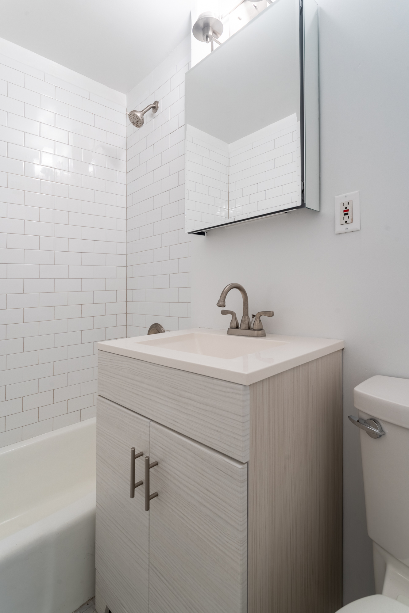 160 East 91st Street, Unit 7N Manhattan, NY 10128 - Photo 11 of 13 a bathroom with a sink a toilet and shower
