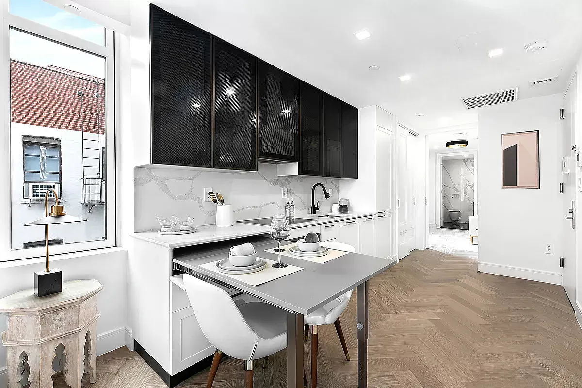 a kitchen with a sink and chairs