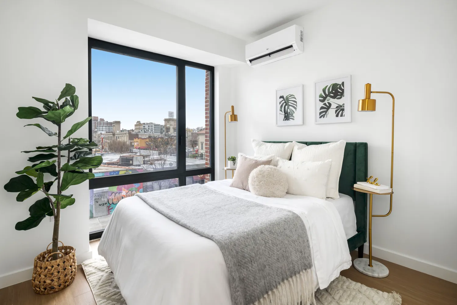 a bedroom with a bed and a potted plant