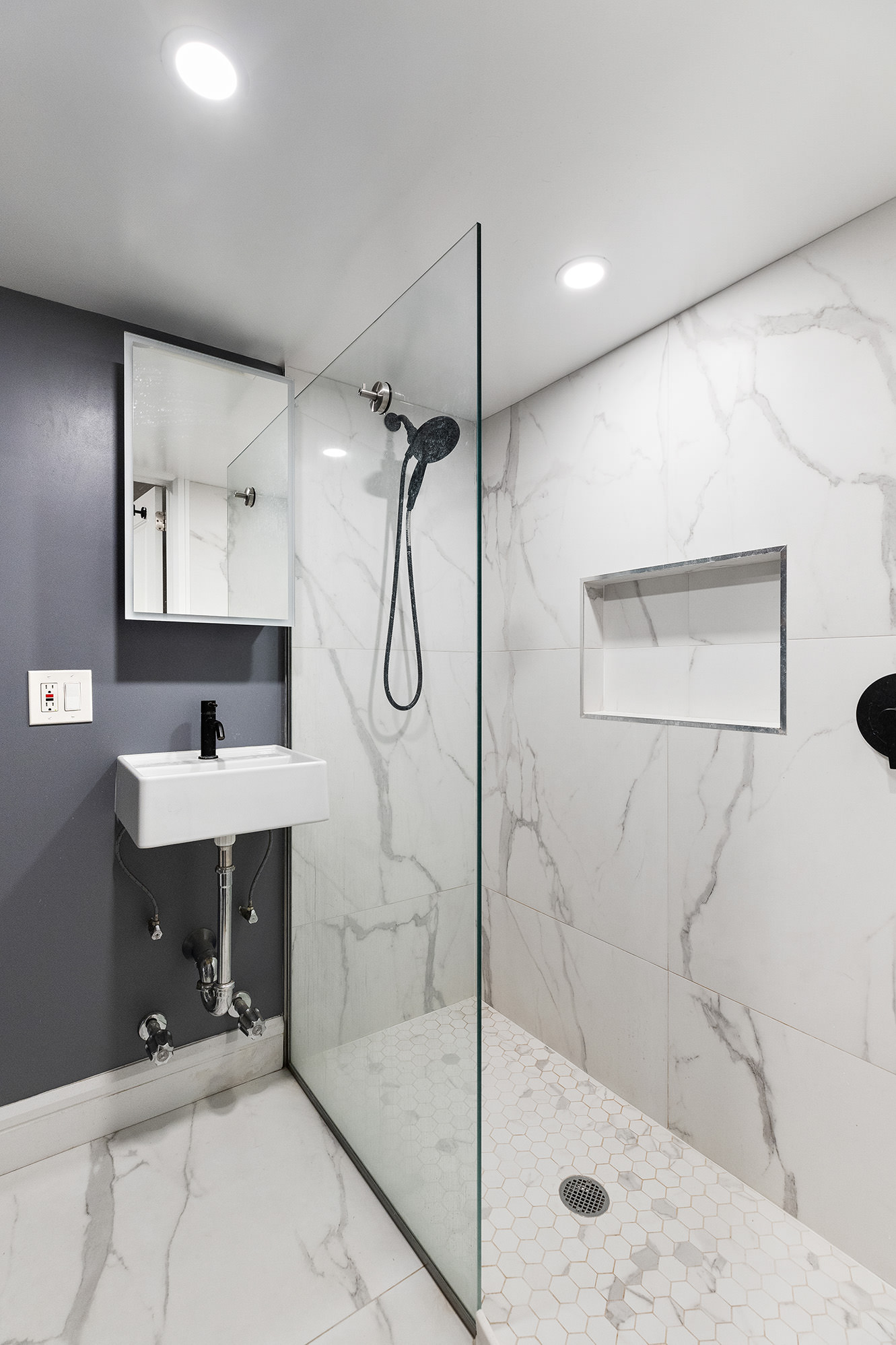 330 East 94th Street, Unit 1AB Manhattan, NY 10128 - Photo 12 of 14 a bathroom with a shower sink and mirror