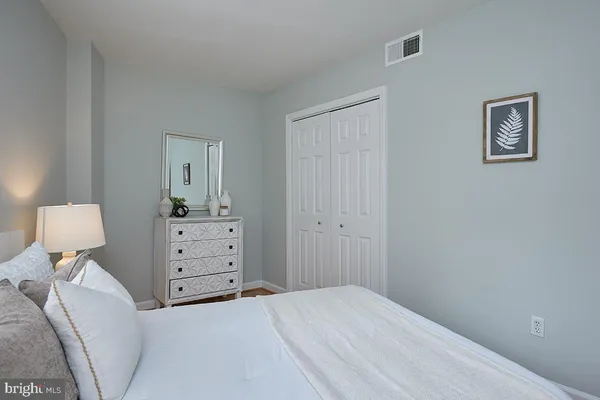 a bedroom with a bed and chair