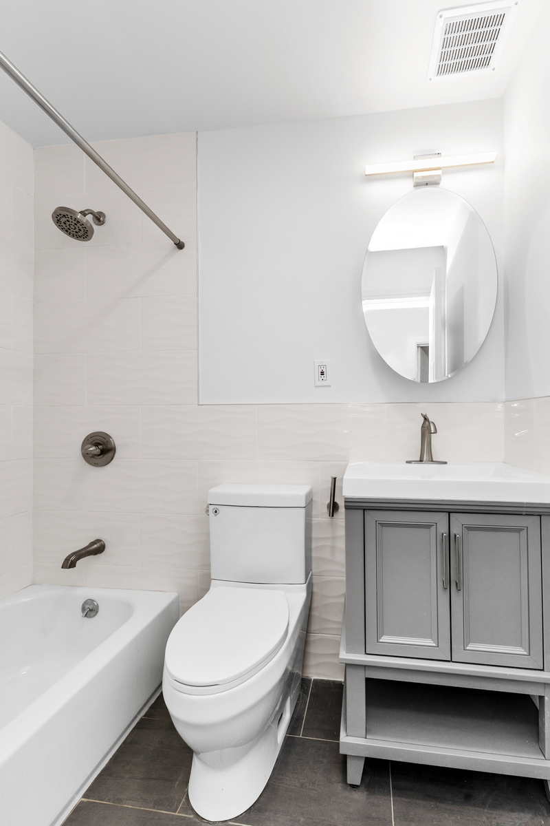 574 Gates Avenue Brooklyn, NY 11221 - Photo 5 of 16 a bathroom with a sink a toilet and bathtub