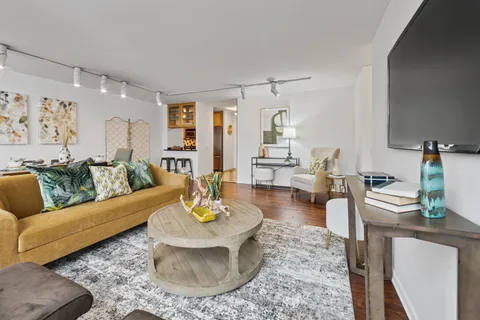 a living room with furniture and a wooden floor