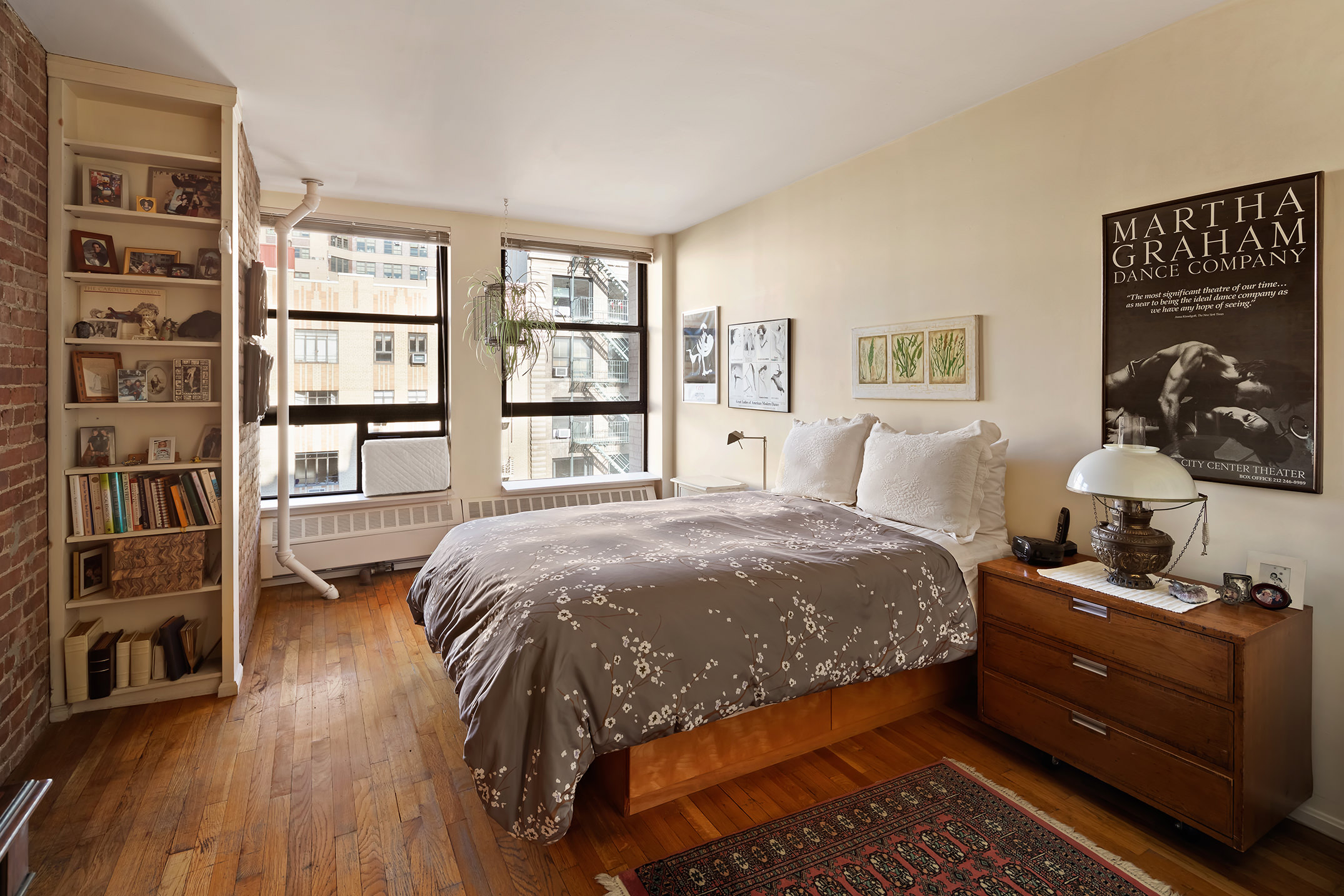 240 West 23rd Street, Unit 5A Manhattan, NY 10011 - Photo 4 of 7 a bedroom with a bed and a cabinets