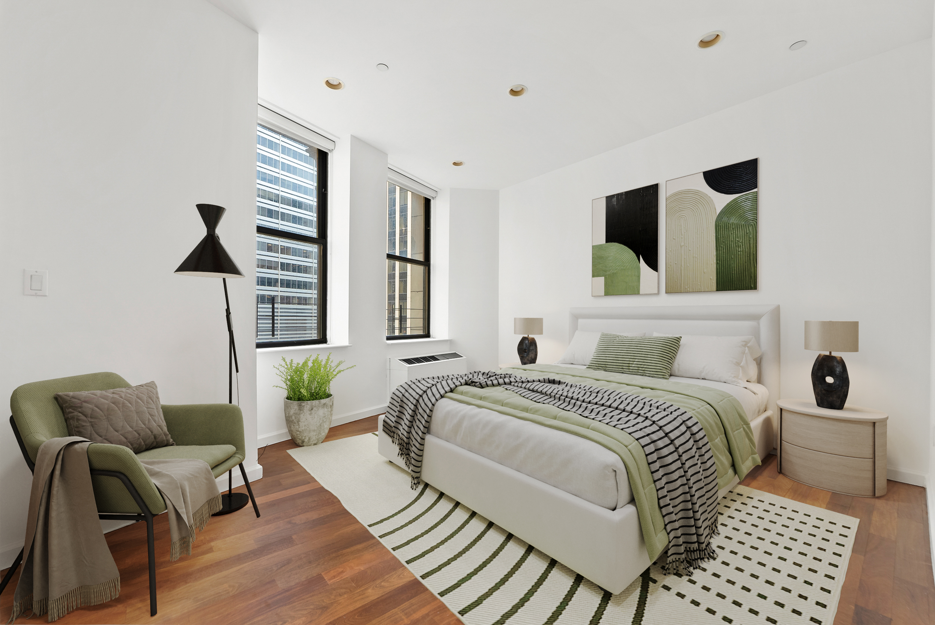 1 Wall Street Court, Unit 1405 Manhattan, NY 10005 - Photo 10 of 19 a bedroom with a bed a couch and a window