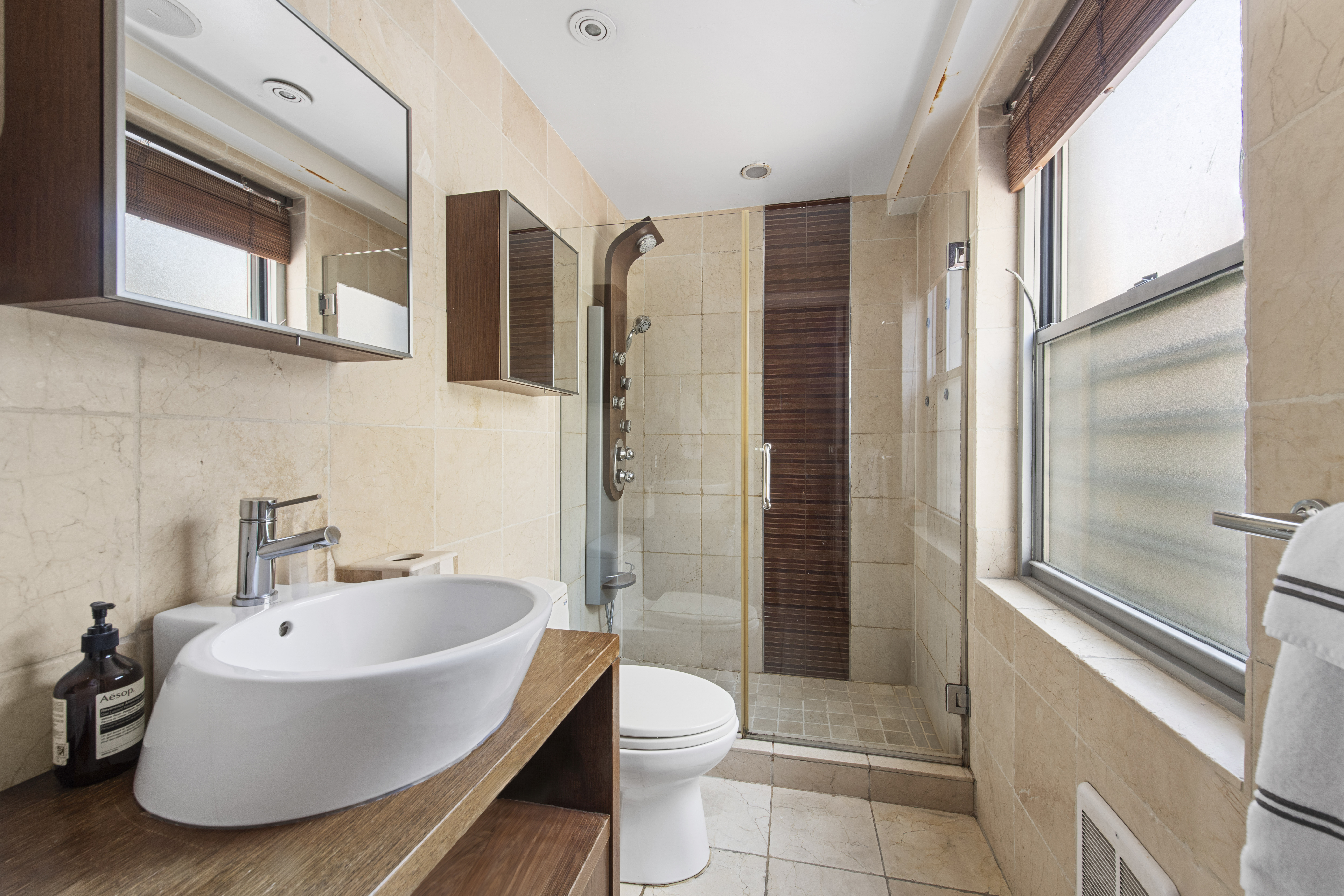 400 East 56th Street, Unit 3D Manhattan, NY 10022 - Photo 15 of 24 a bathroom with a toilet a sink and a bathtub