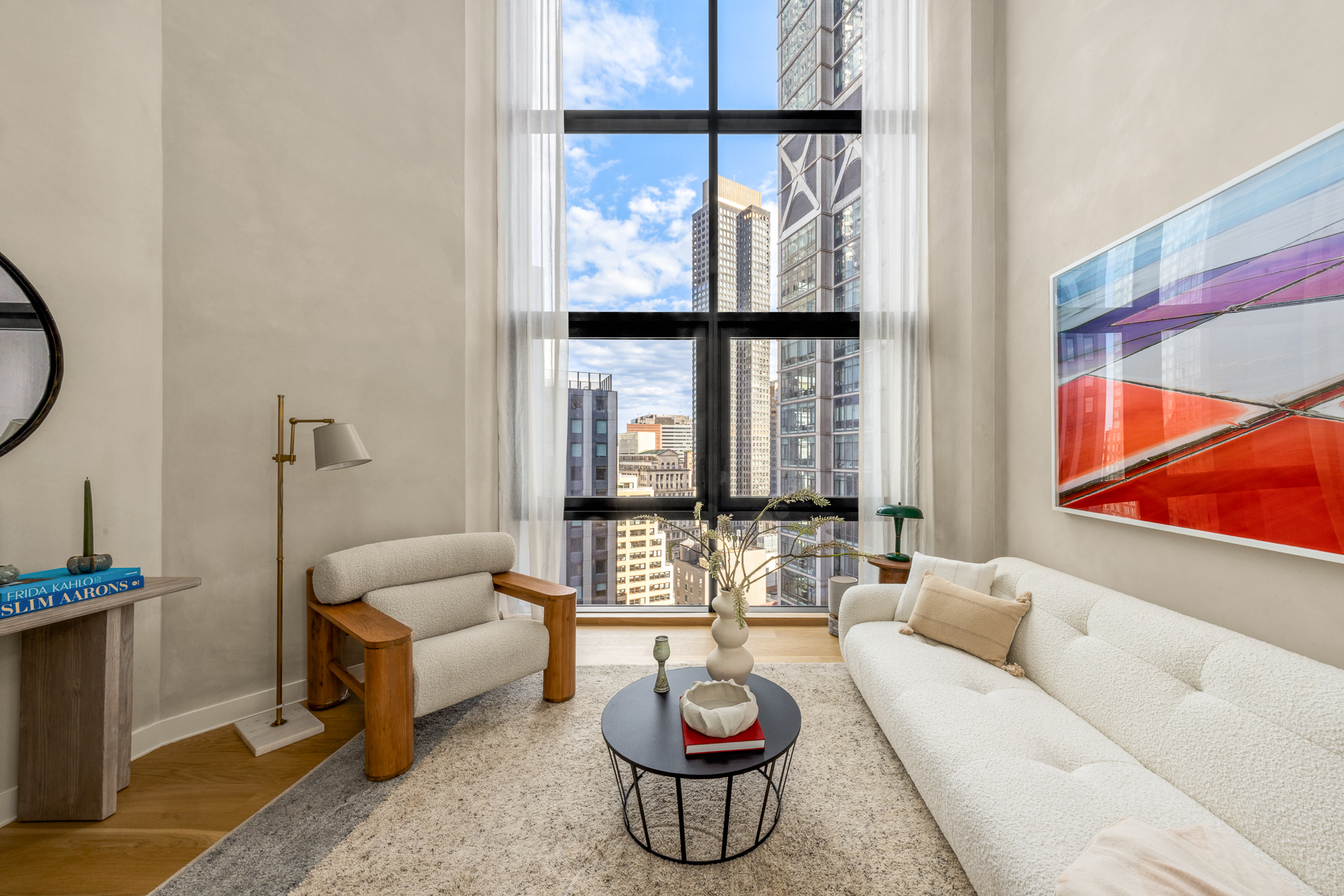 33 Park Row, Unit PH1 Manhattan, NY 10038 - Photo 11 of 15 a living room with furniture and a floor to ceiling window