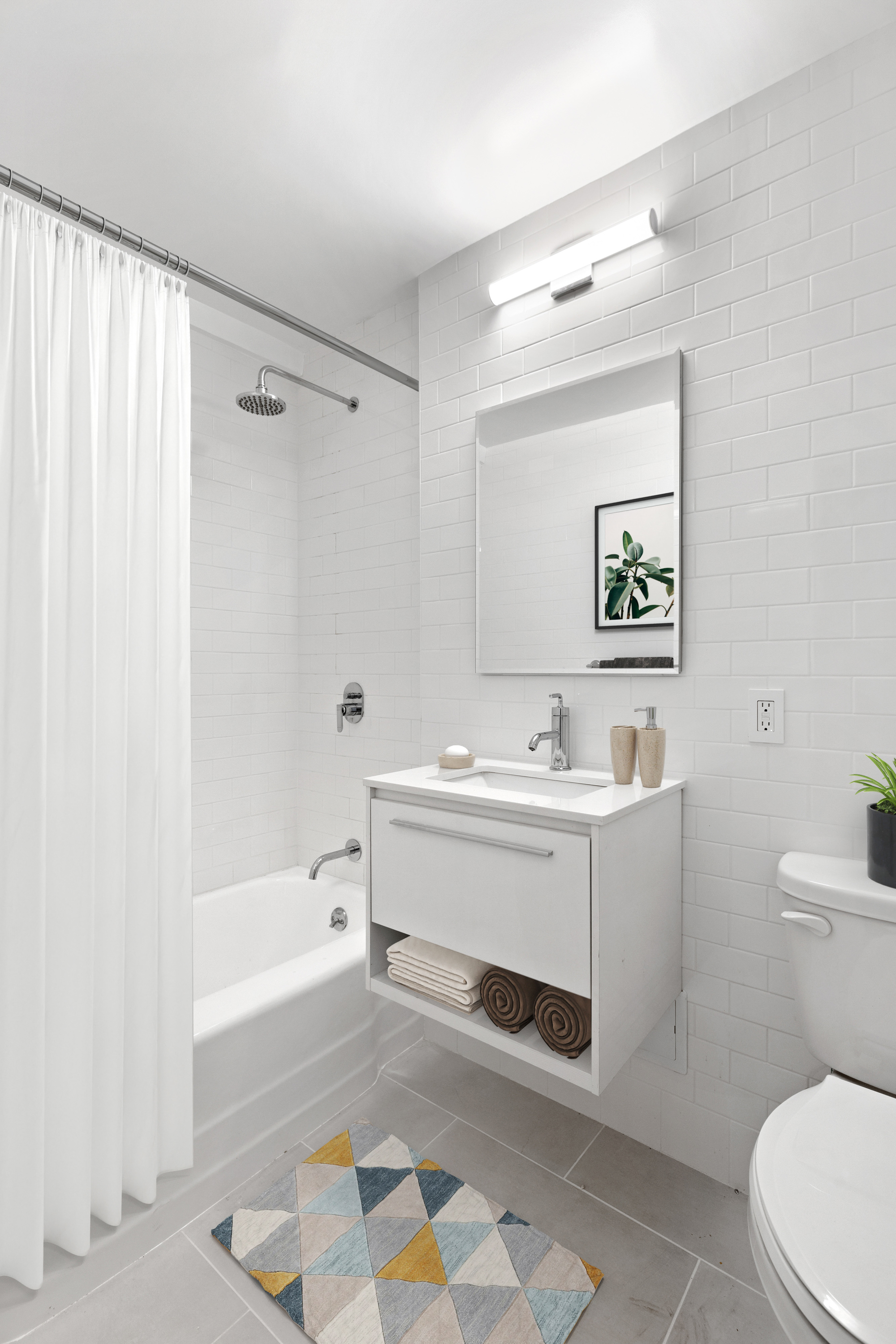 165 Christopher Street, Unit 1DD Manhattan, NY 10014 - Photo 6 of 14 a bathroom with a sink and a bathtub