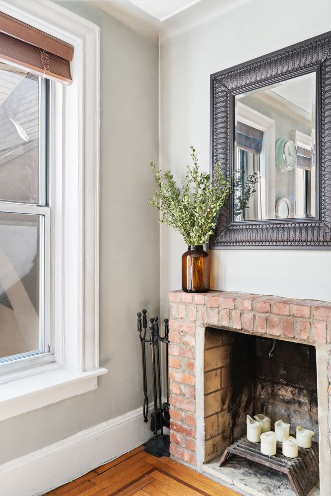 104 Bedford Street, Unit 4C Manhattan, NY 10014 - Photo 2 of 9 a living room with a fireplace and a potted plant