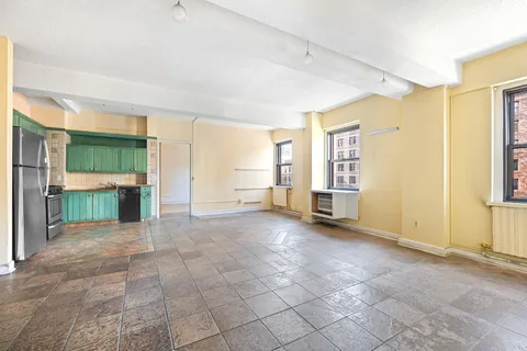 a view of a livingroom with an empty space and a window