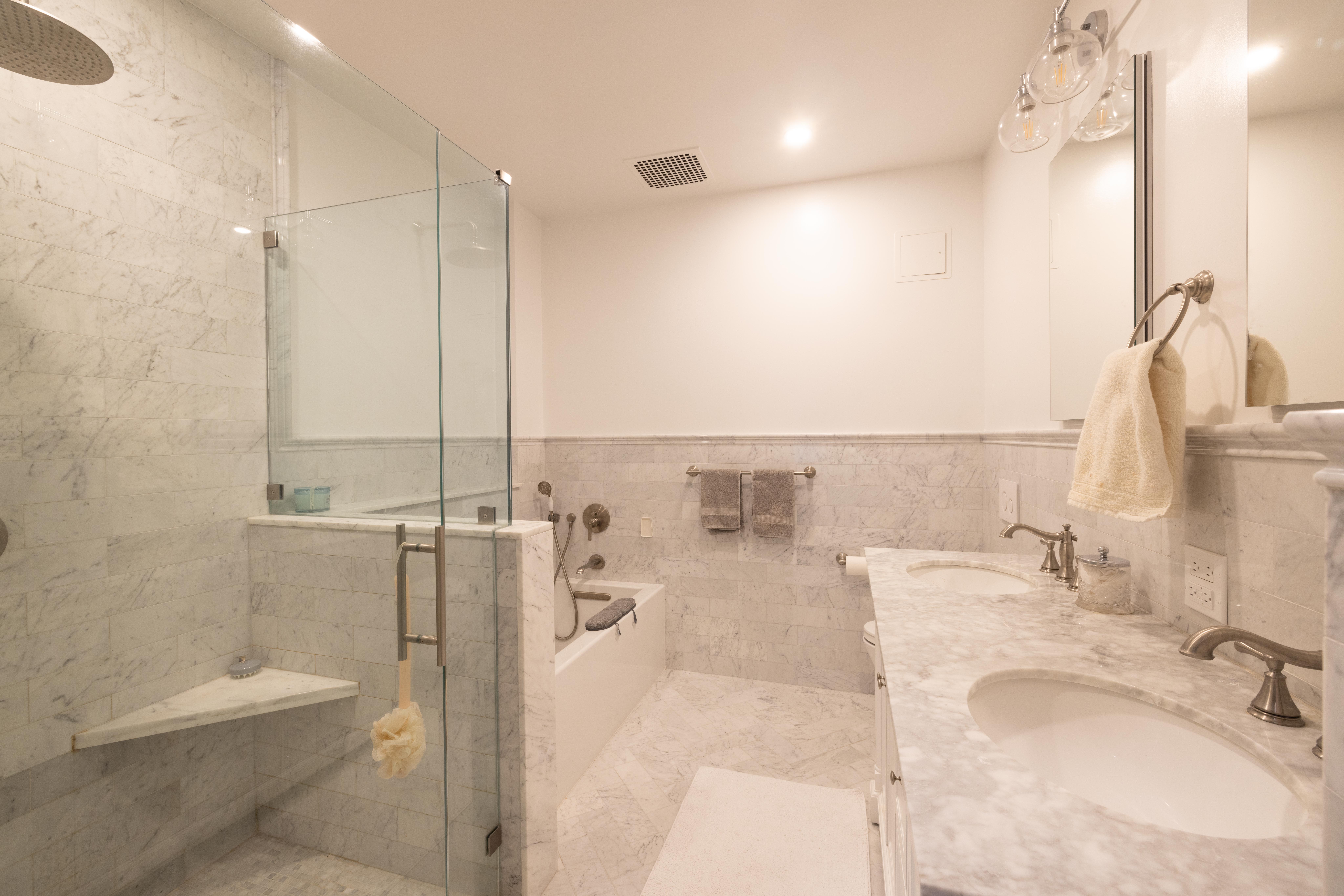 107 East 38th Street, Unit 2AB Manhattan, NY 10016 - Photo 7 of 13 a bathroom with a tub sink and mirror