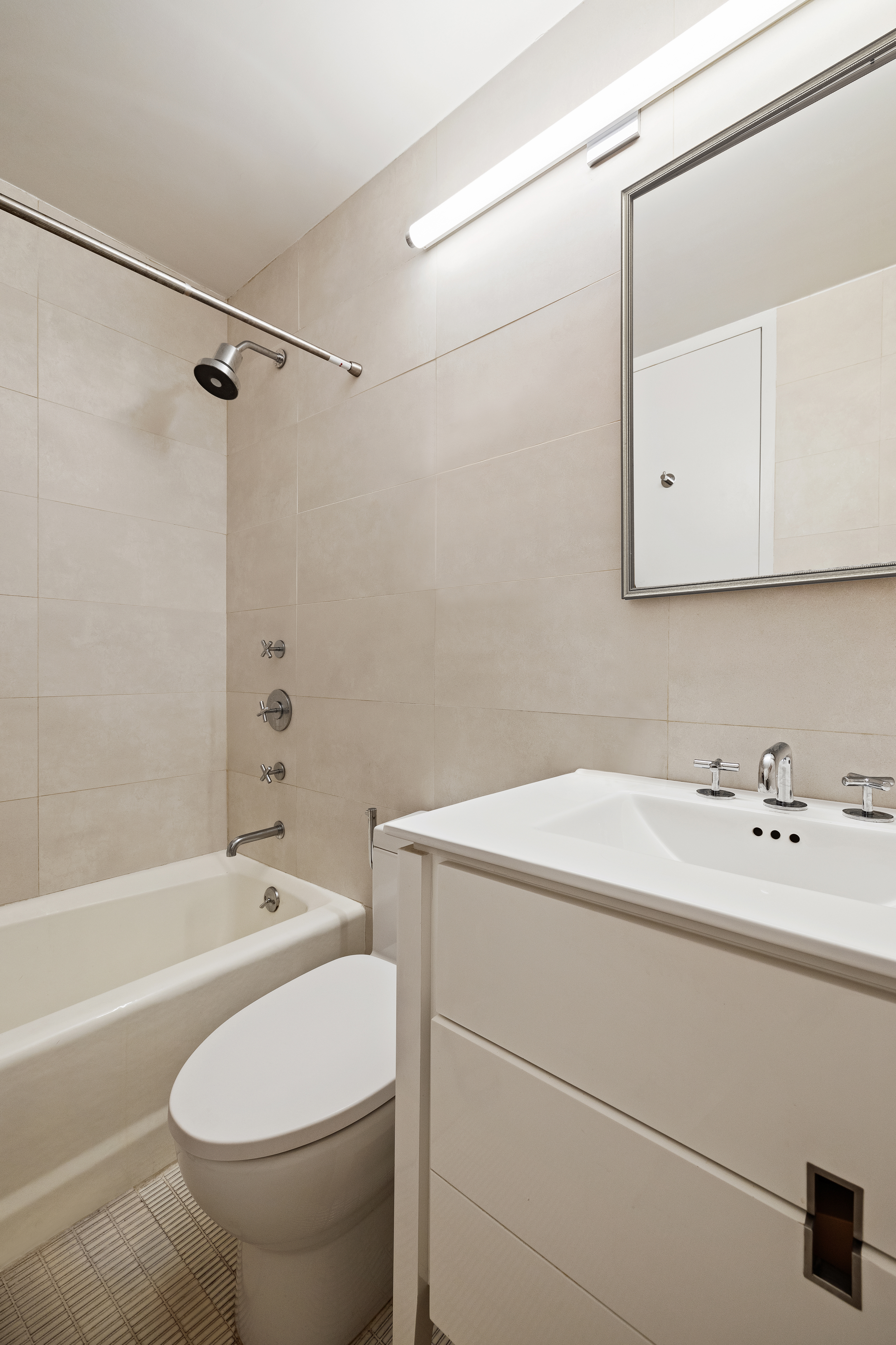 1 Irving Place, Unit P20G Manhattan, NY 10003 - Photo 6 of 8 a bathroom with a sink a toilet and a bathtub