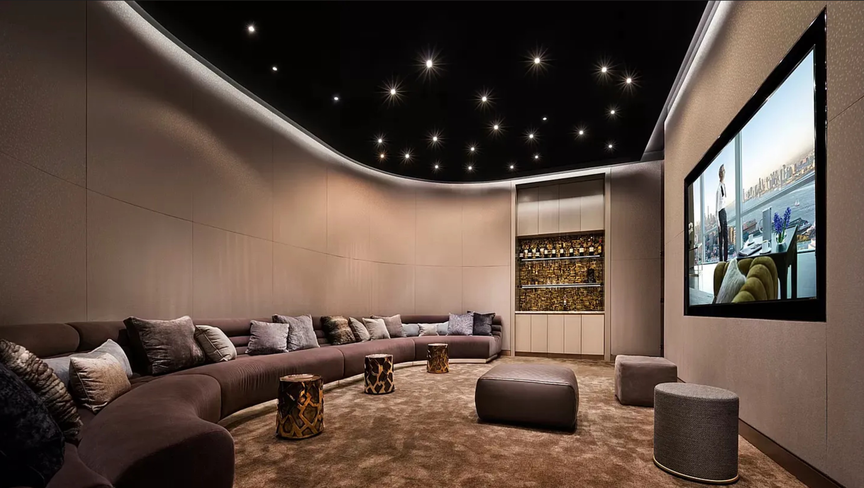 35 Hudson Yards, Unit 6701 Manhattan, NY 10001 - Photo 20 of 23 a media room with lots of chairs and a projector screen