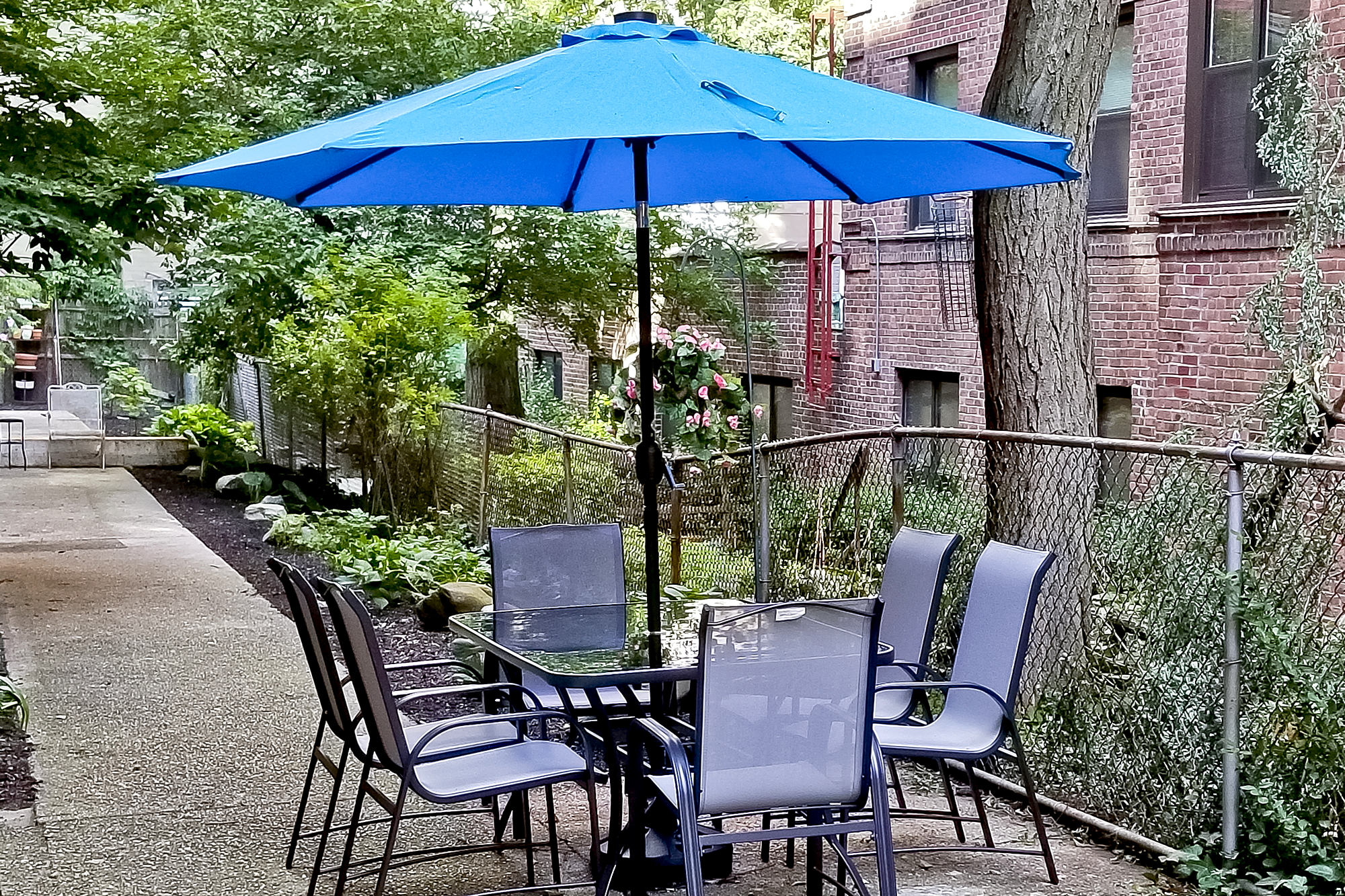 3210 Arlington Avenue, Unit 3D Bronx, NY 10463 - Photo 11 of 24 a patio with a table and chairs under an umbrella