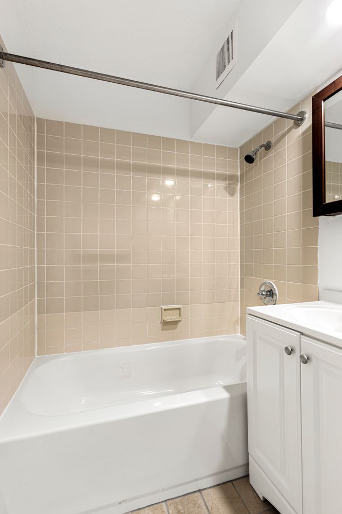 376 Broadway, Unit 8F Manhattan, NY 10013 - Photo 15 of 20 a bathroom with a bathtub and a shower
