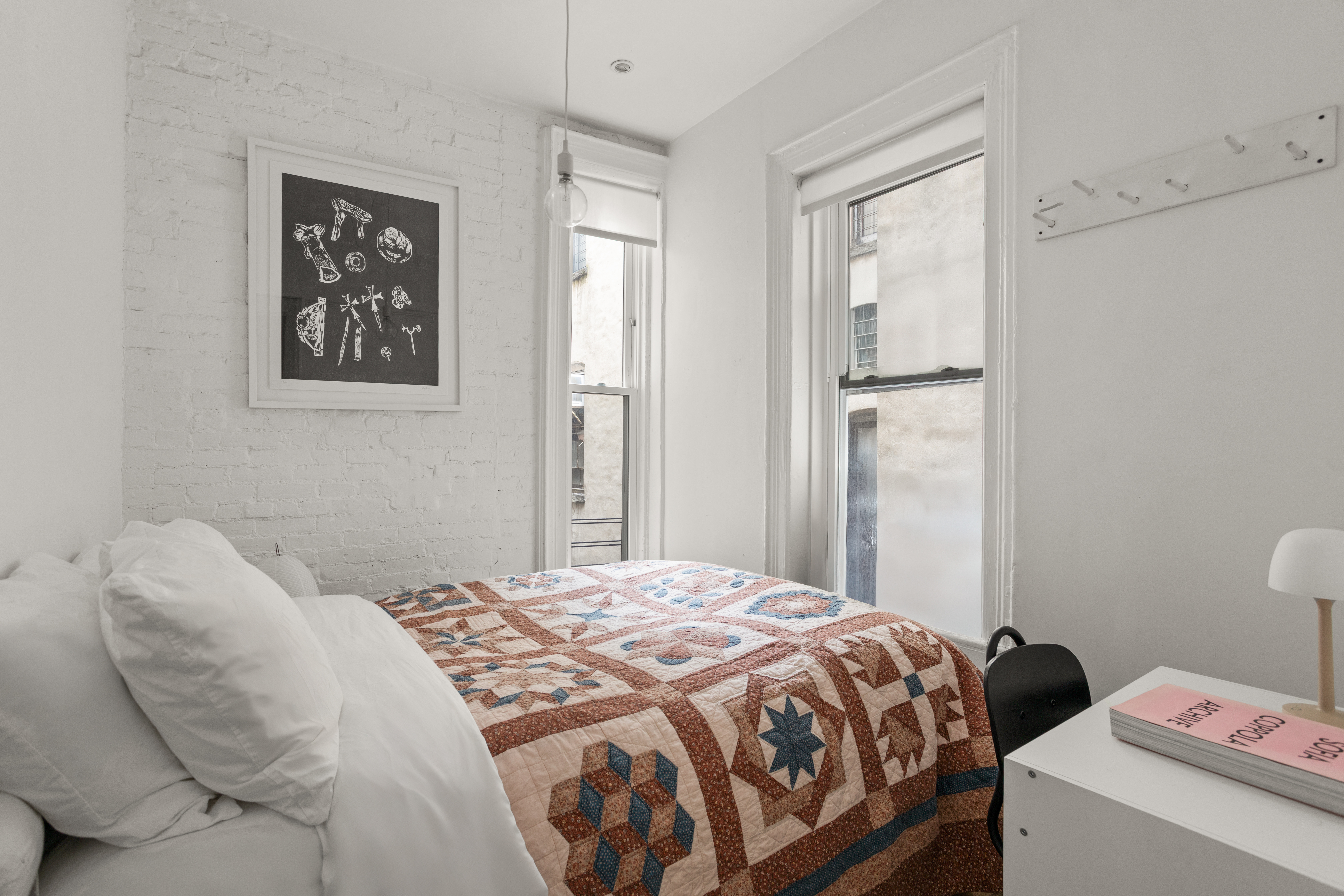 248 East 7th Street, Unit 19/20 Manhattan, NY 10009 - Photo 5 of 7 a bedroom with a bed and a window