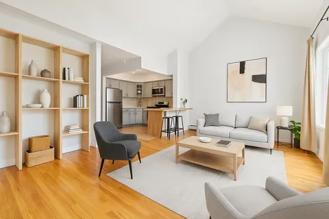 a living room with furniture and a book shelf