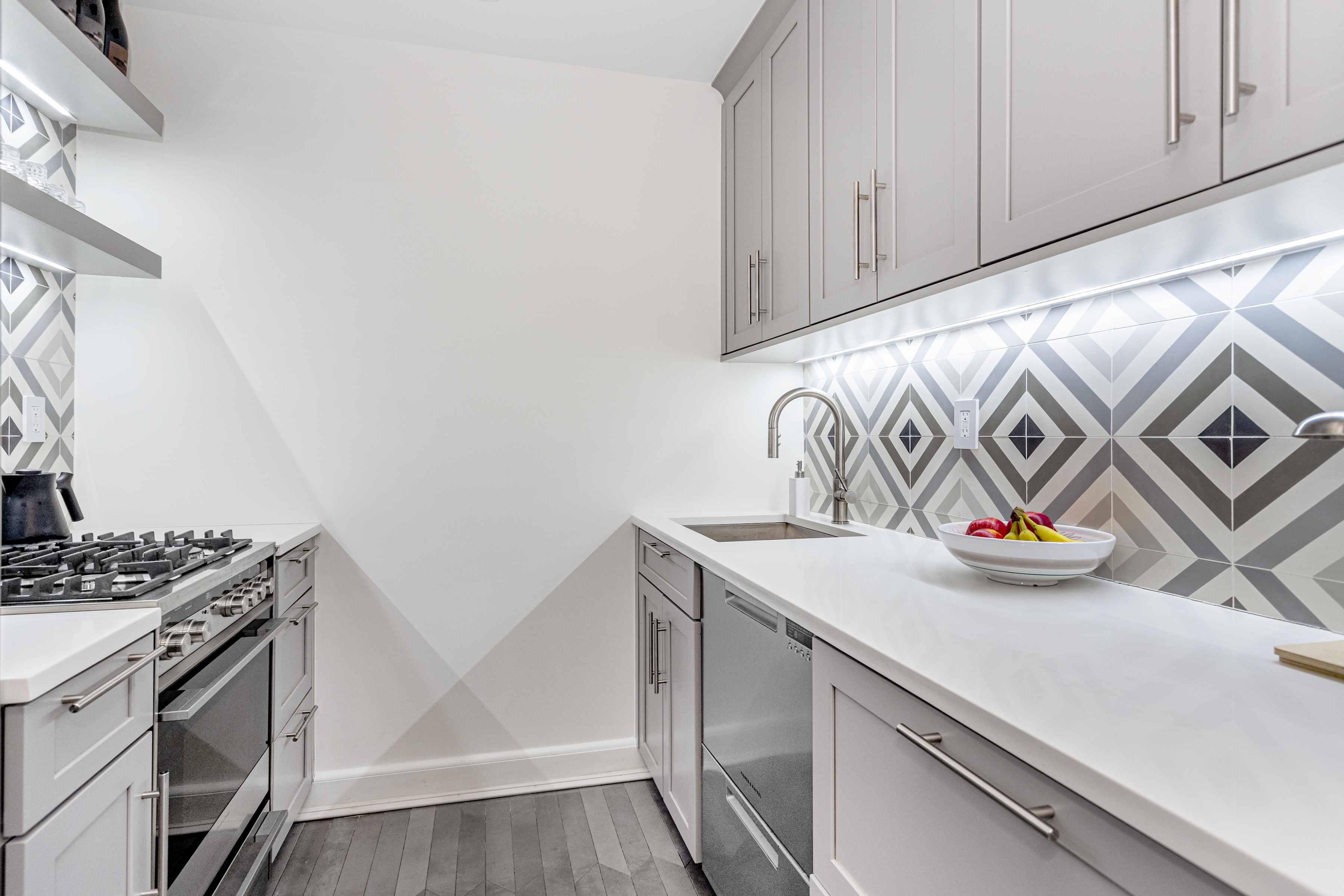 250 West 15th Street, Unit 3C Manhattan, NY 10011 - Photo 3 of 9 a kitchen with stainless steel appliances granite countertop a sink and a stove