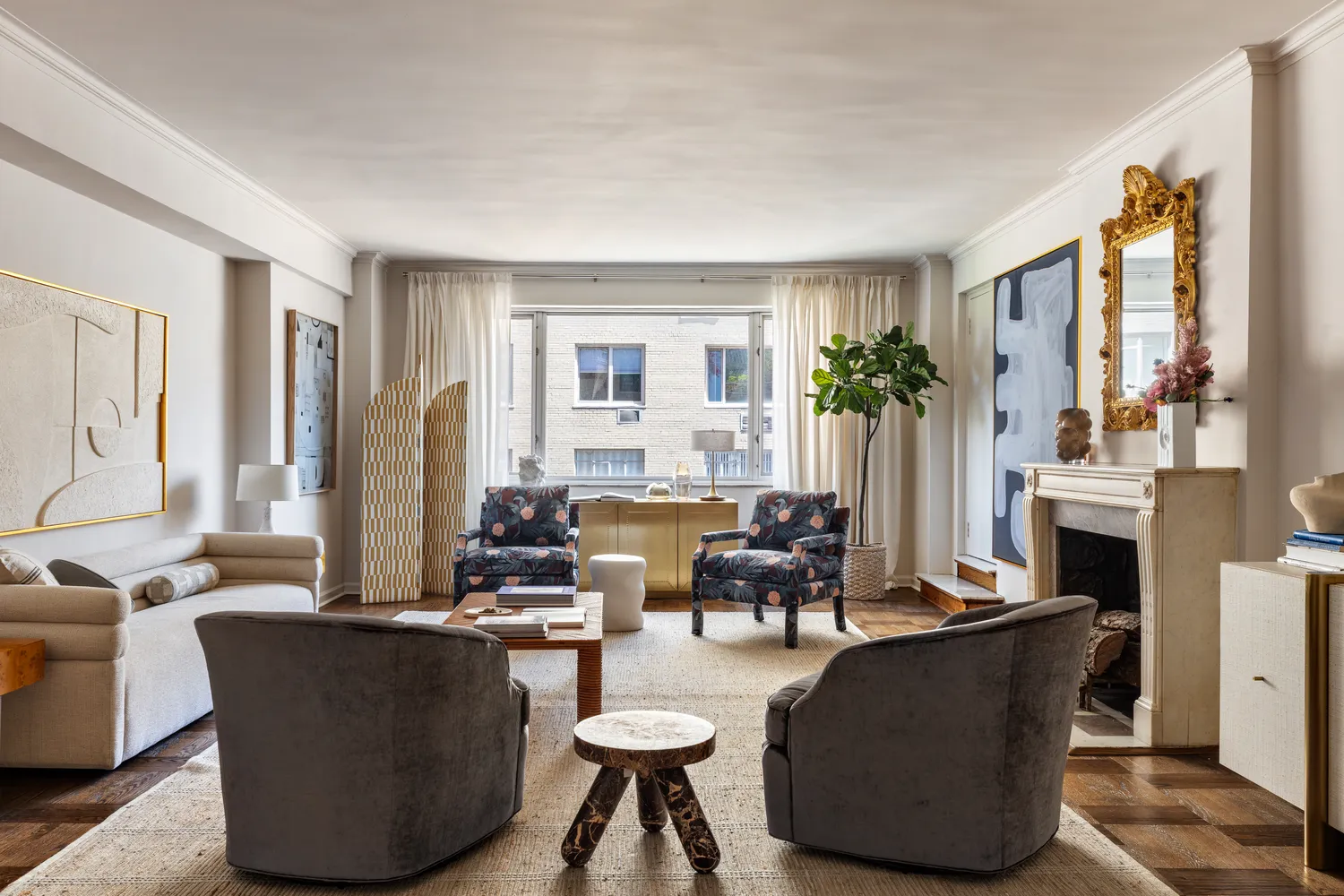 a living room with fireplace furniture and a large window