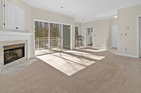 a view of an empty room with a fireplace