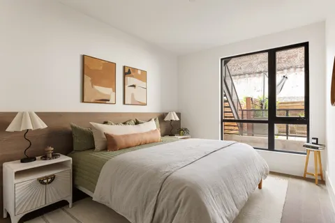 a bedroom with a large bed and a large window