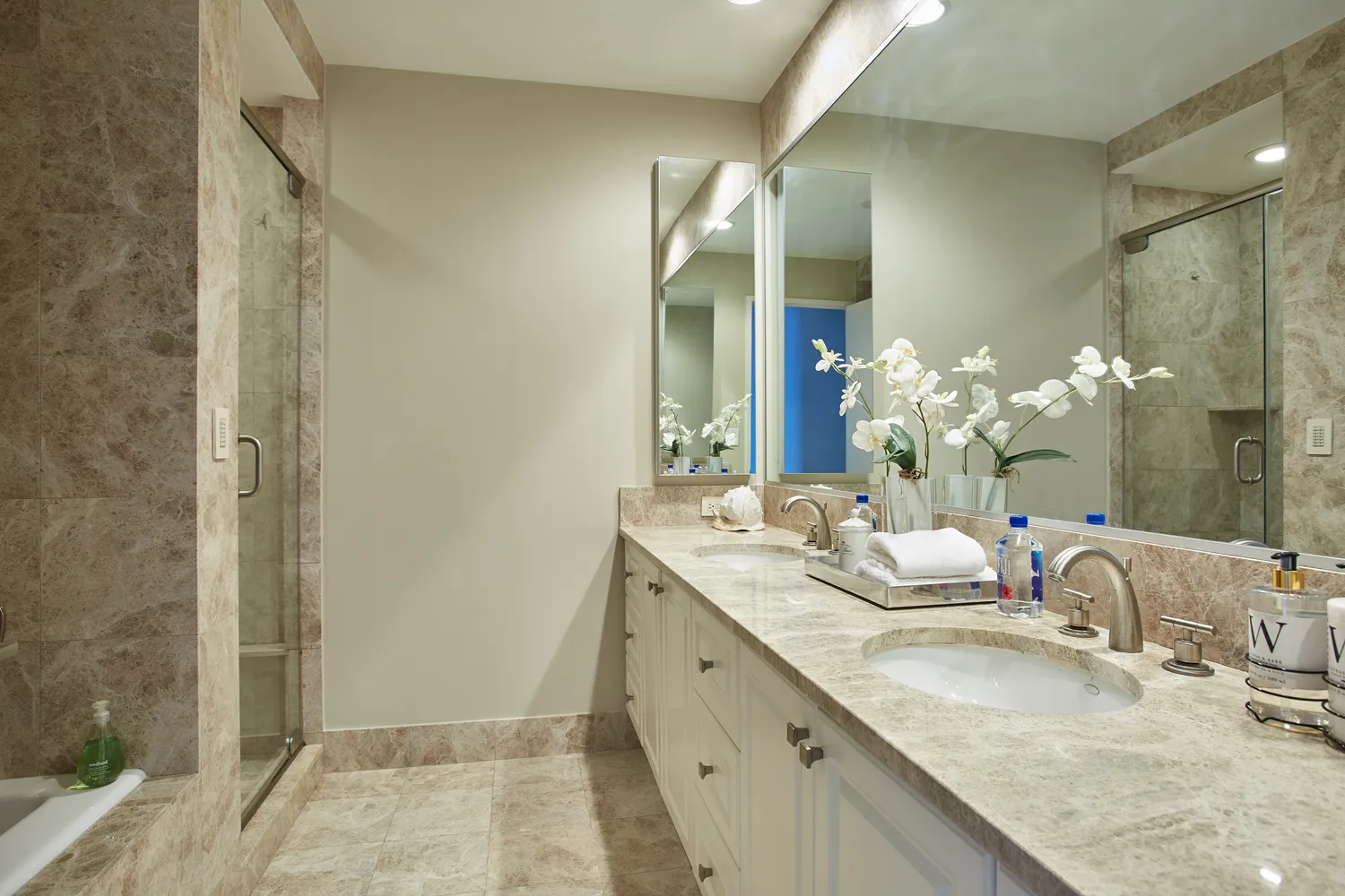 a bathroom with a granite countertop double vanity sink and a mirror