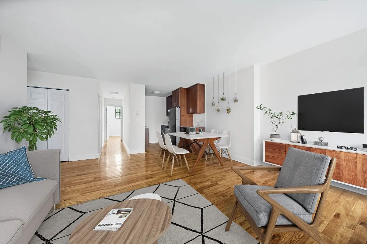 138 Baltic Street, Unit 3C Brooklyn, NY 11201 - Photo 2 of 10 a living room with furniture and a flat screen tv
