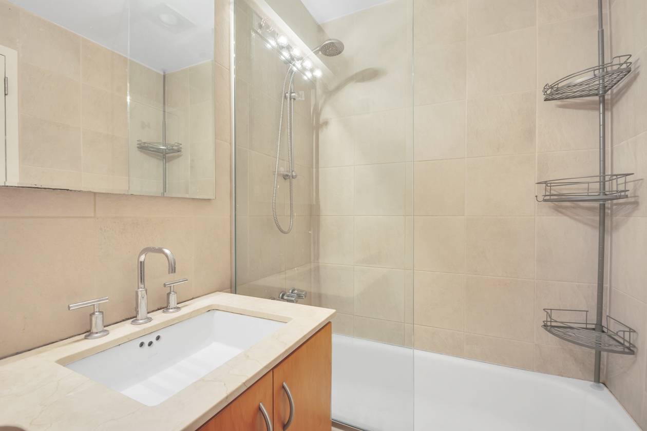 65 Cooper Square, Unit 3D Manhattan, NY 10003 - Photo 10 of 11 a bathroom with a sink a toilet and shower