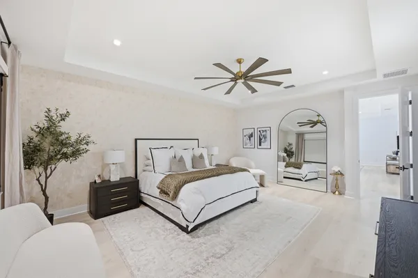 a living room with a bed and a flat screen tv