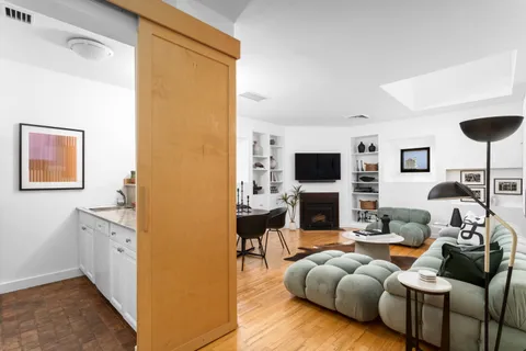 a living room with furniture fireplace and a flat screen tv