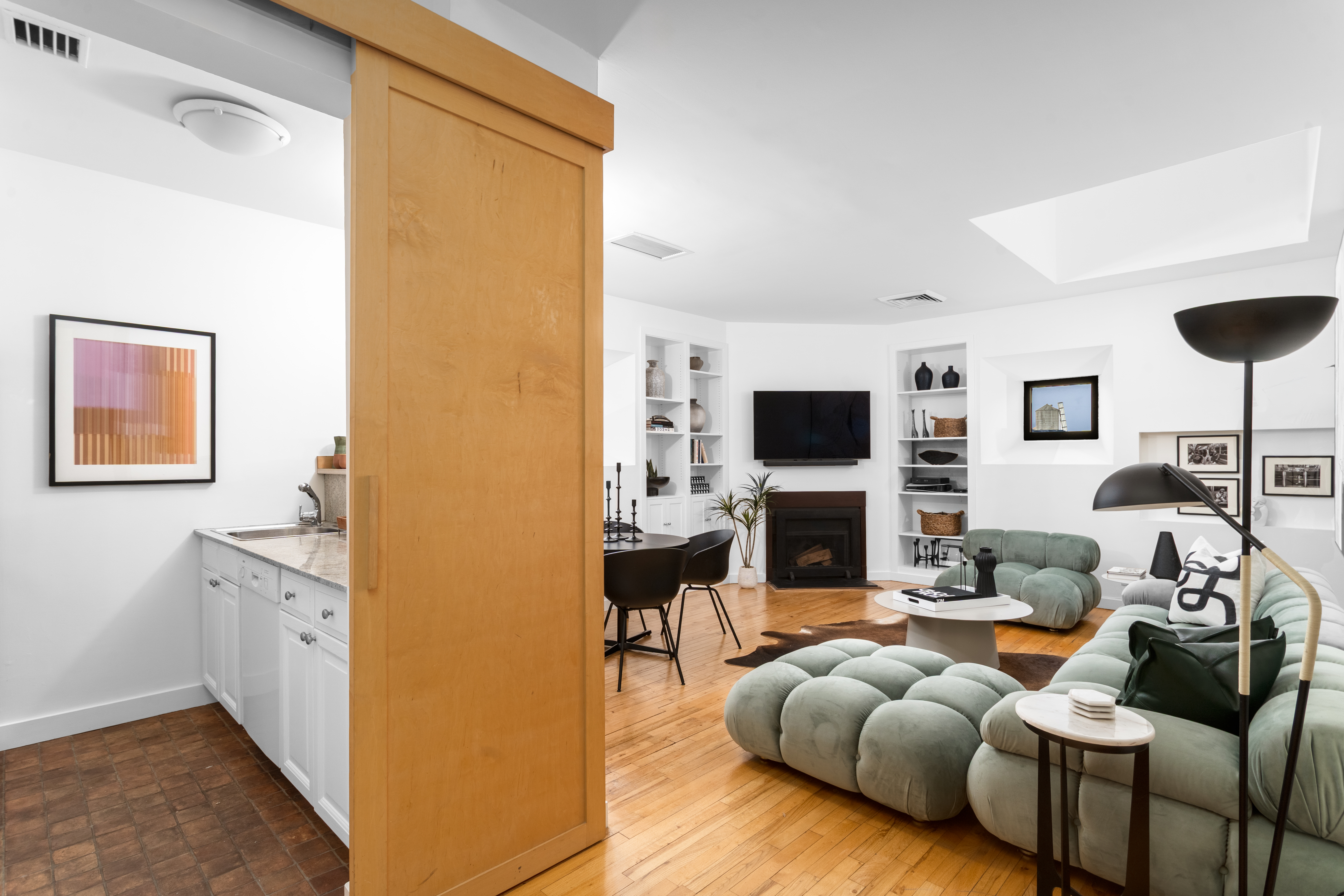 205 West 89th Street, Unit PH8 Manhattan, NY 10024 - Photo 4 of 15 a living room with furniture fireplace and a flat screen tv