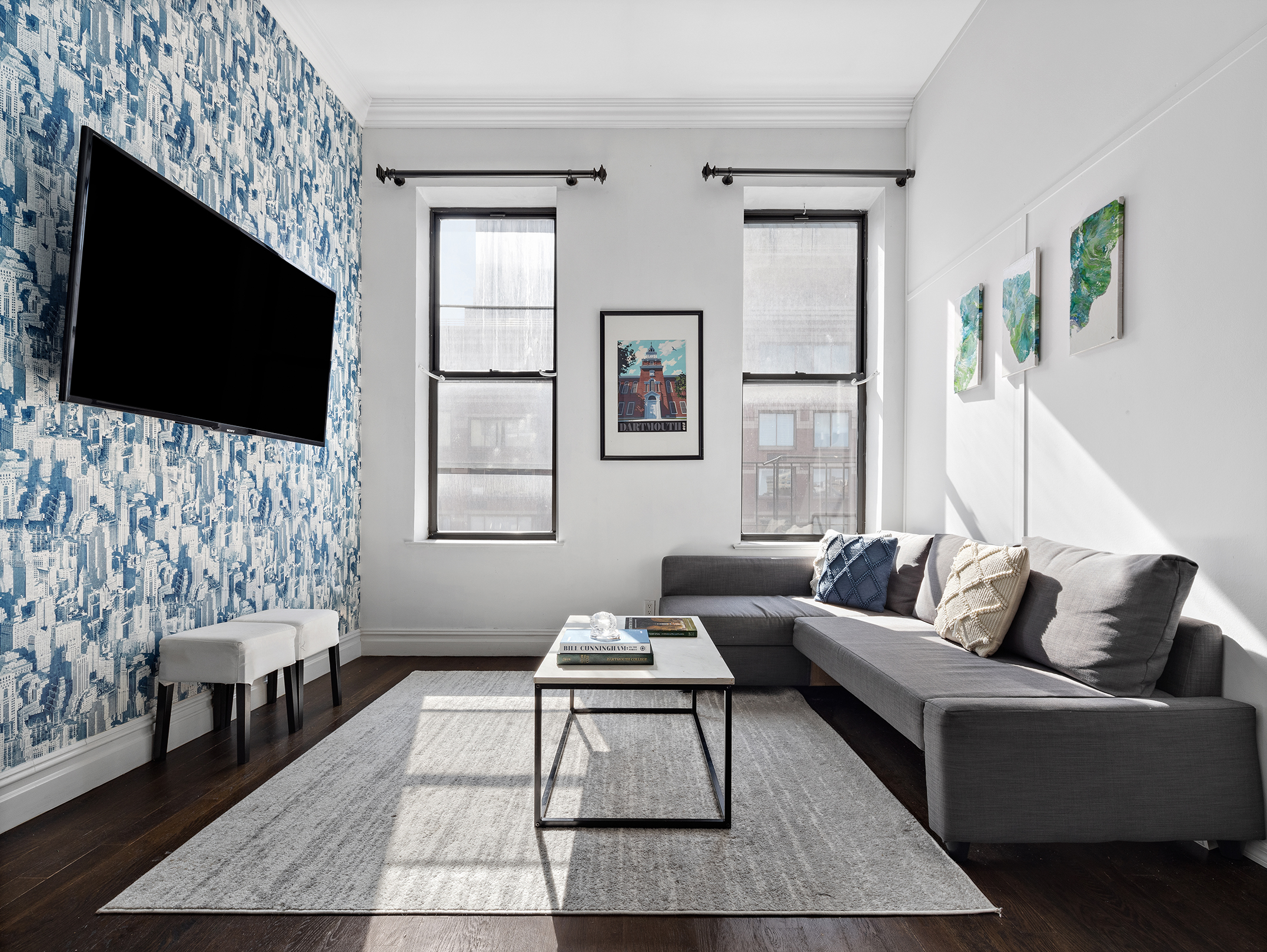 733 9th Avenue, Unit 5 Manhattan, NY 10019 - Photo 2 of 9 a living room with furniture a flat screen tv and a fireplace
