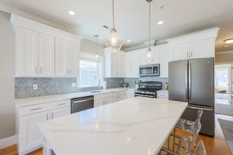a kitchen with stainless steel appliances a refrigerator sink and microwave