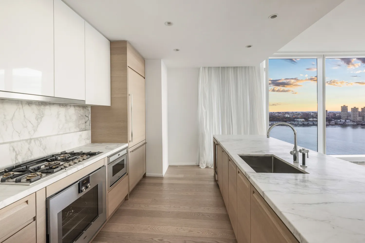 a kitchen with granite countertop a sink stove and cabinets