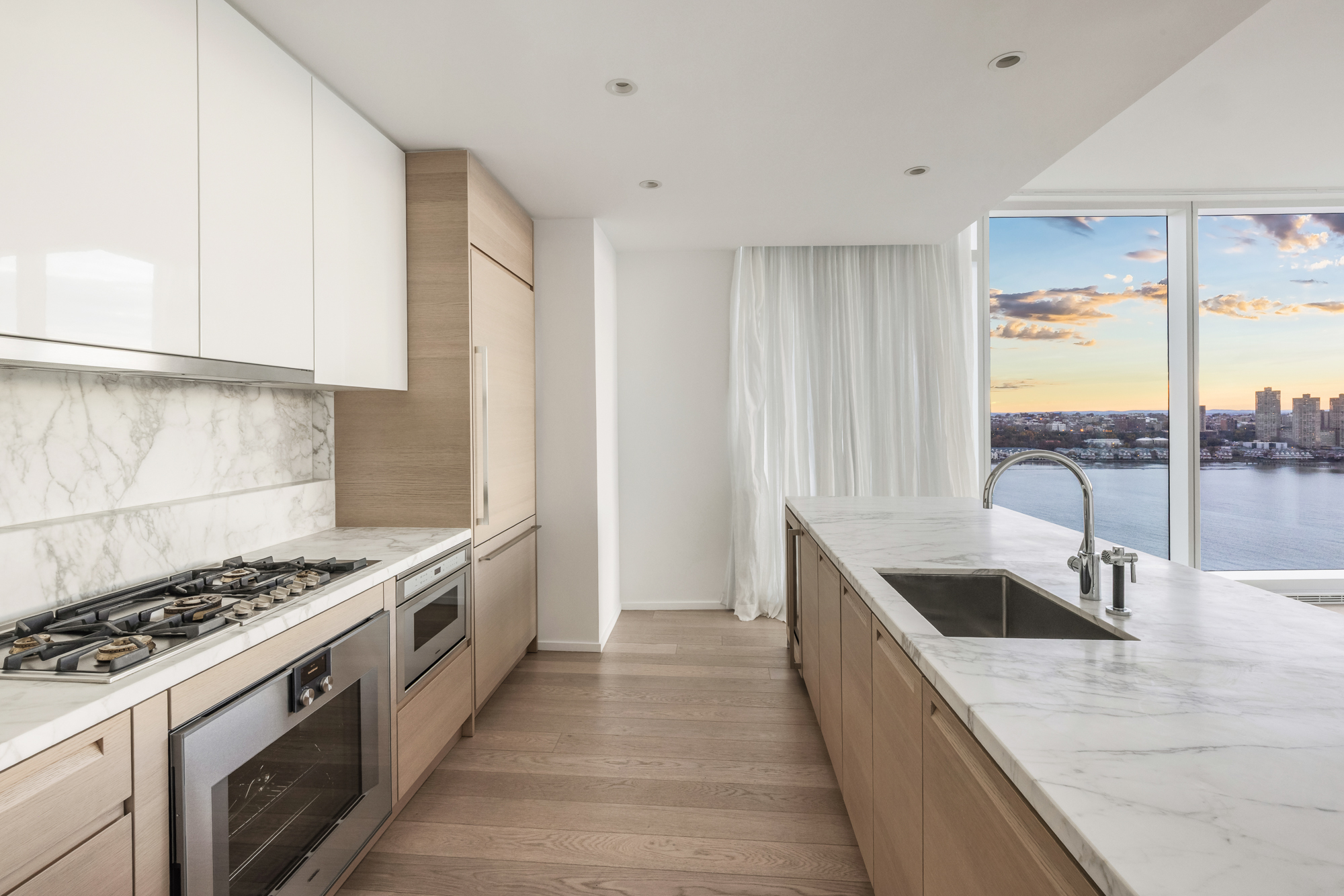 30 Riverside Boulevard, Unit 29B Manhattan, NY 10069 - Photo 7 of 20 a kitchen with granite countertop a sink stove and cabinets