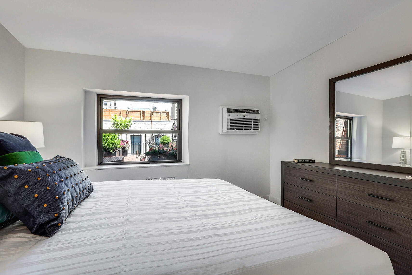 237 East 17th Street, Unit 520 Manhattan, NY 10003 - Photo 9 of 14 a bedroom with a large bed and a window