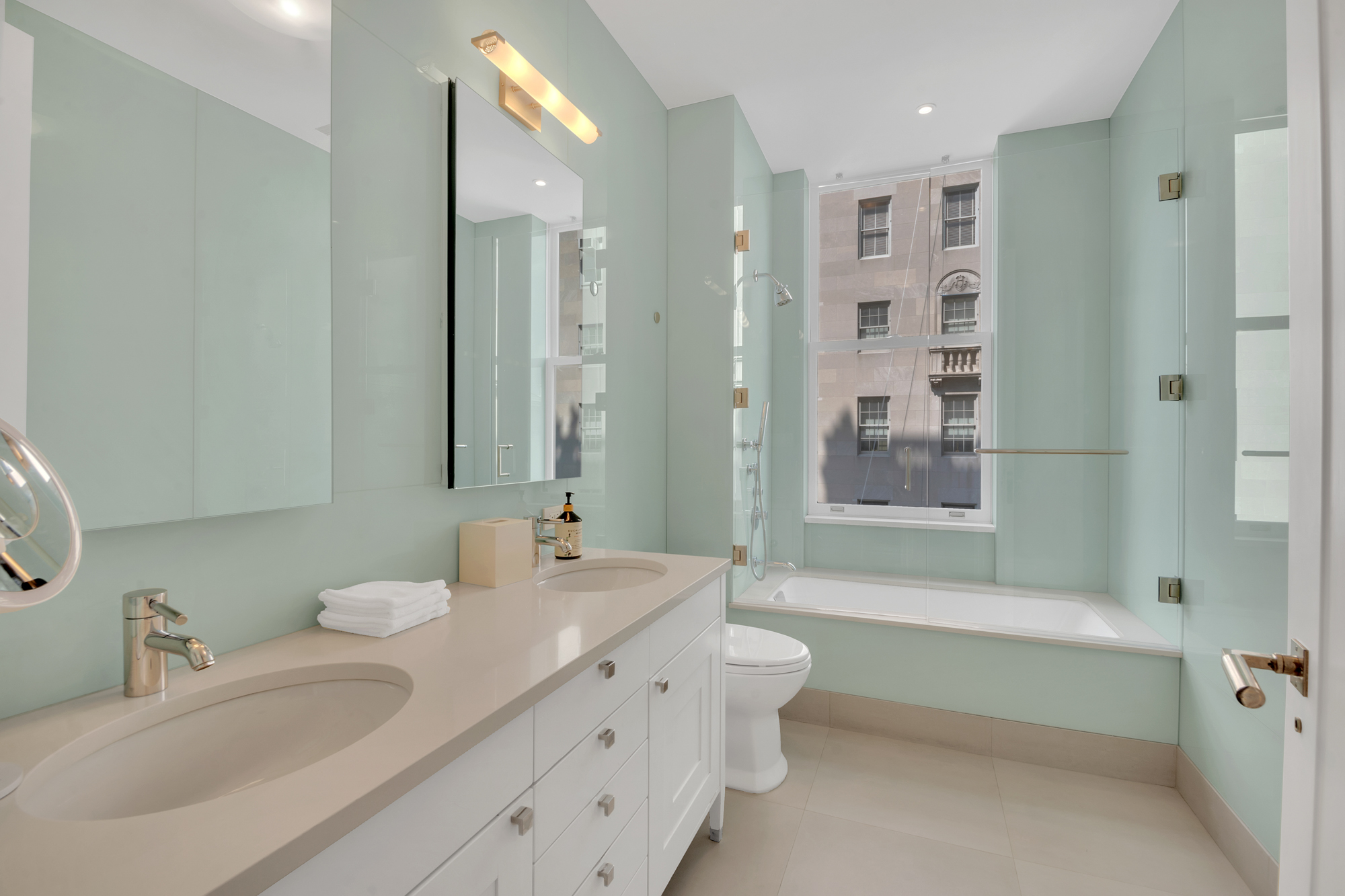 988 5th Avenue Manhattan, NY 10075 - Photo 12 of 14 a bathroom with a double vanity sink mirror double and bathtub