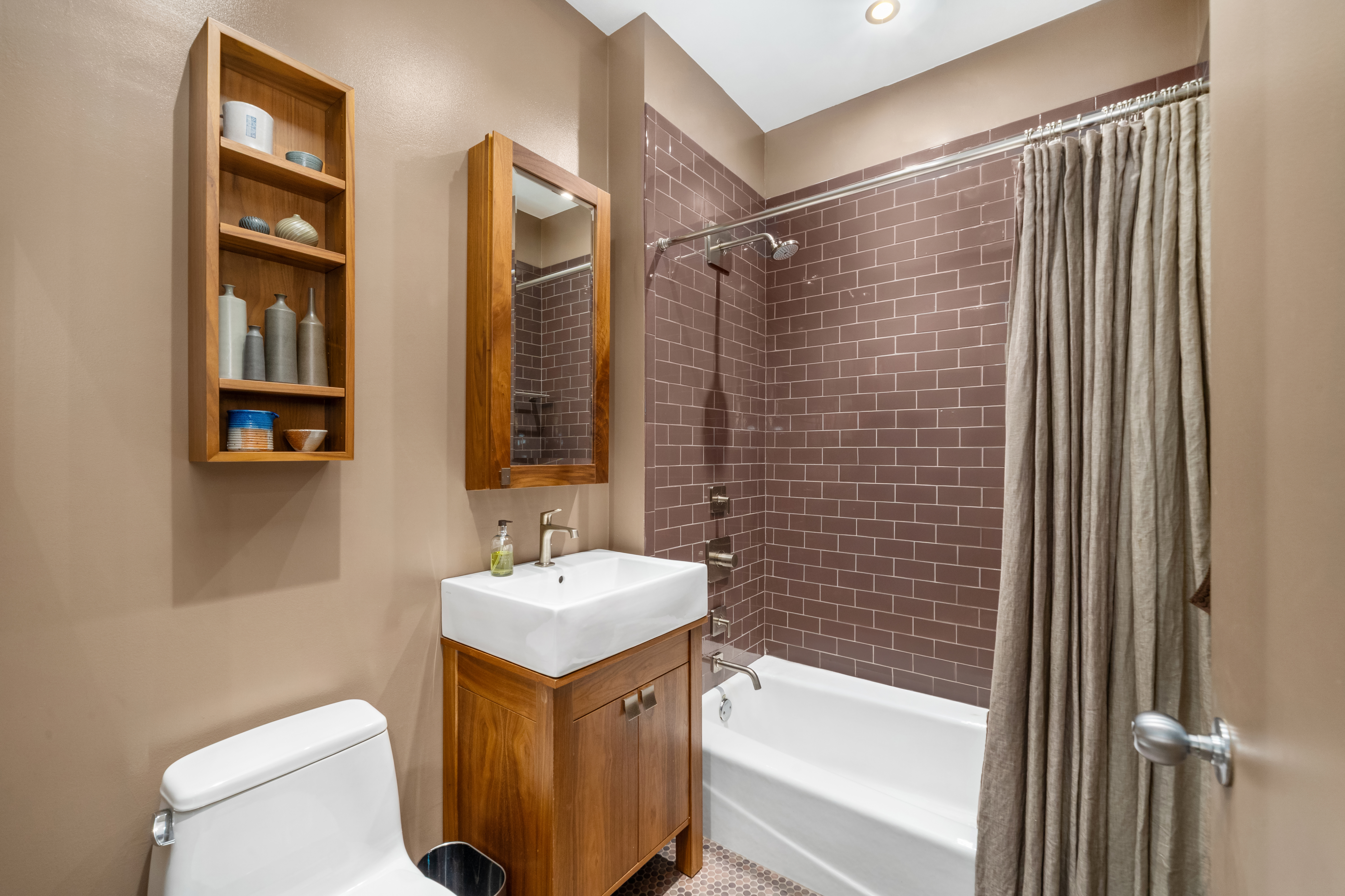 252 7th Avenue, Unit 9D Manhattan, NY 10001 - Photo 19 of 23 a bathroom with a sink toilet and shower