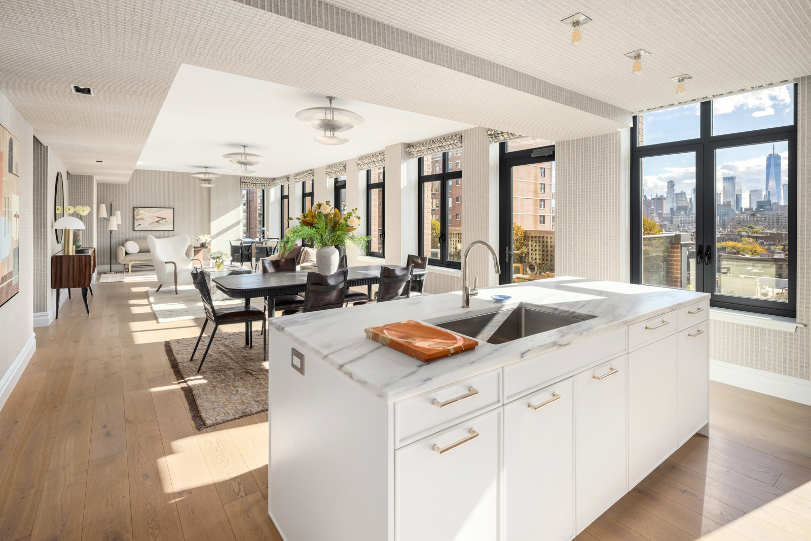 245 West 14th Street, Unit T3 Manhattan, NY 10011 - Photo 9 of 24 a dining hall with stainless steel appliances granite countertop a sink and white cabinets next to a large window