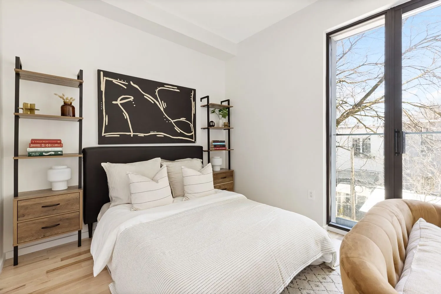 a bedroom with a bed and a painting on the wall