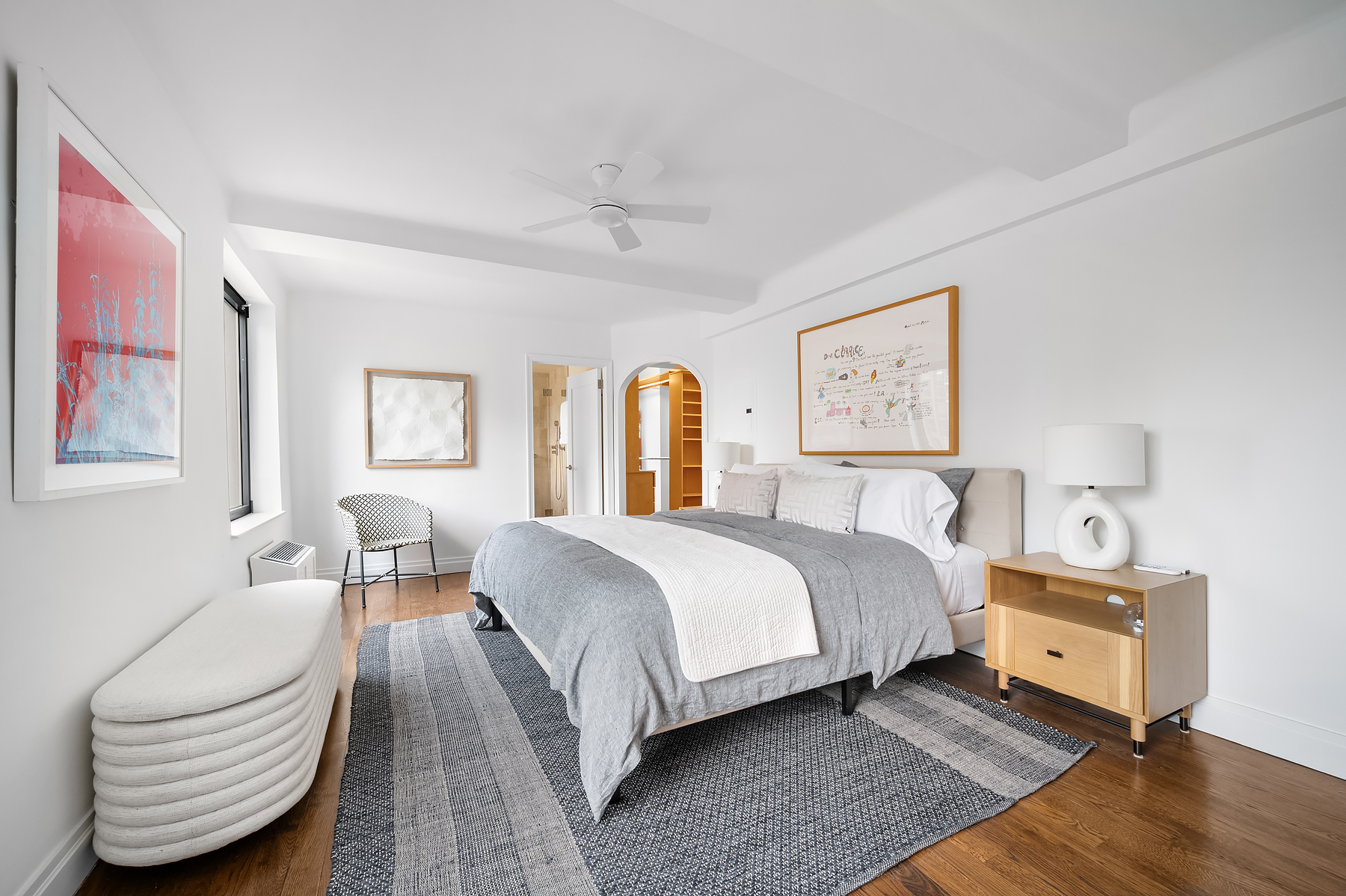 227 East 57th Street, Unit 18BF Manhattan, NY 10022 - Photo 9 of 17 a bedroom with a bed and wooden floor