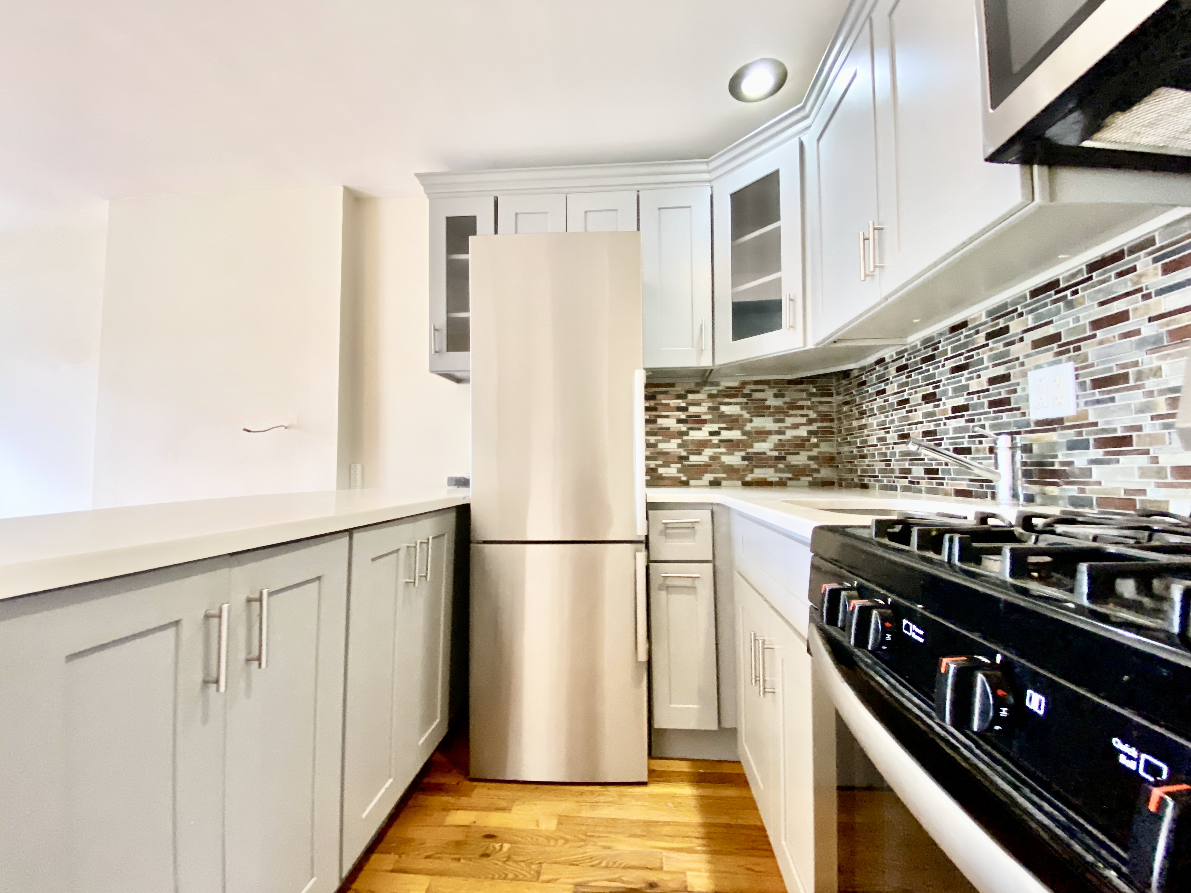 373 Gates Avenue, Unit 4 Brooklyn, NY 11216 - Photo 5 of 10 a kitchen with stainless steel appliances a refrigerator and a stove