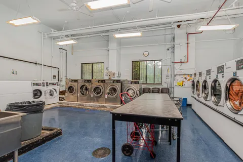 a view of a patio with table and chairs with wooden floor and fence