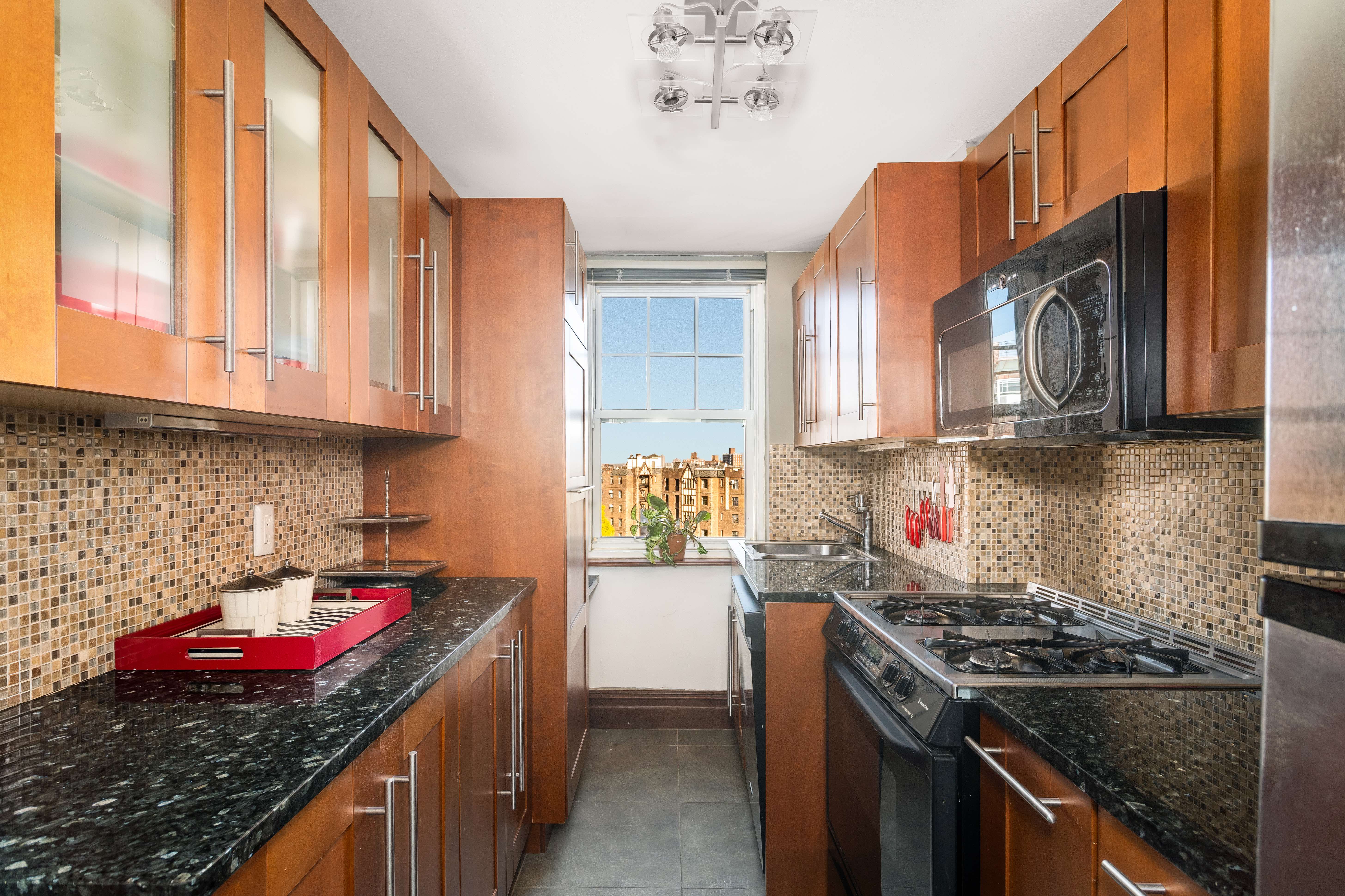 140 Cabrini Boulevard, Unit PH138 Manhattan, NY 10033 - Photo 6 of 30 a kitchen with stainless steel appliances granite countertop a stove and cabinets