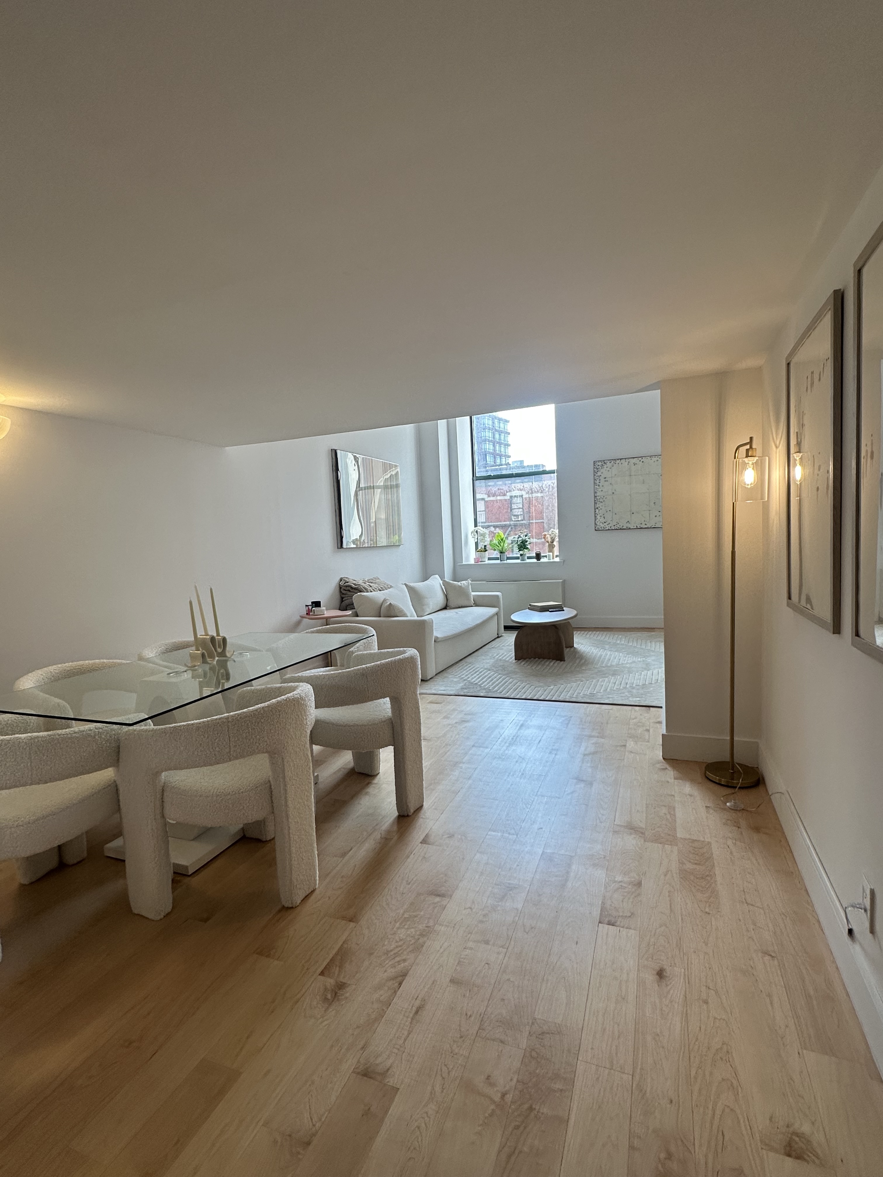666 Greenwich Street, Unit 350 Manhattan, NY 10014 - Photo 5 of 13 a large white kitchen with a sink and dishwasher a stove with wooden floor