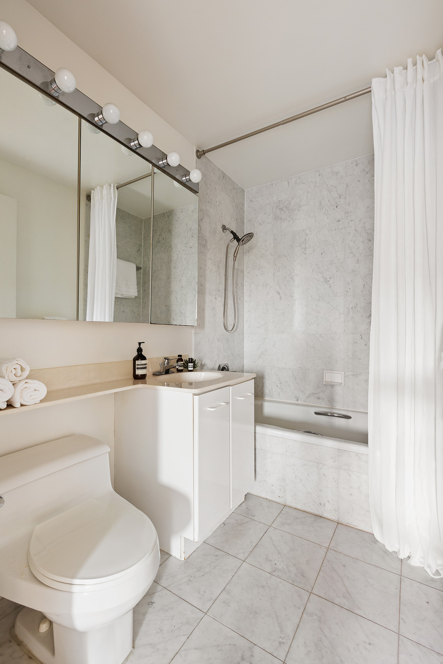 2 South End Avenue, Unit 7B Manhattan, NY 10280 - Photo 10 of 17 a bathroom with a sink toilet and shower