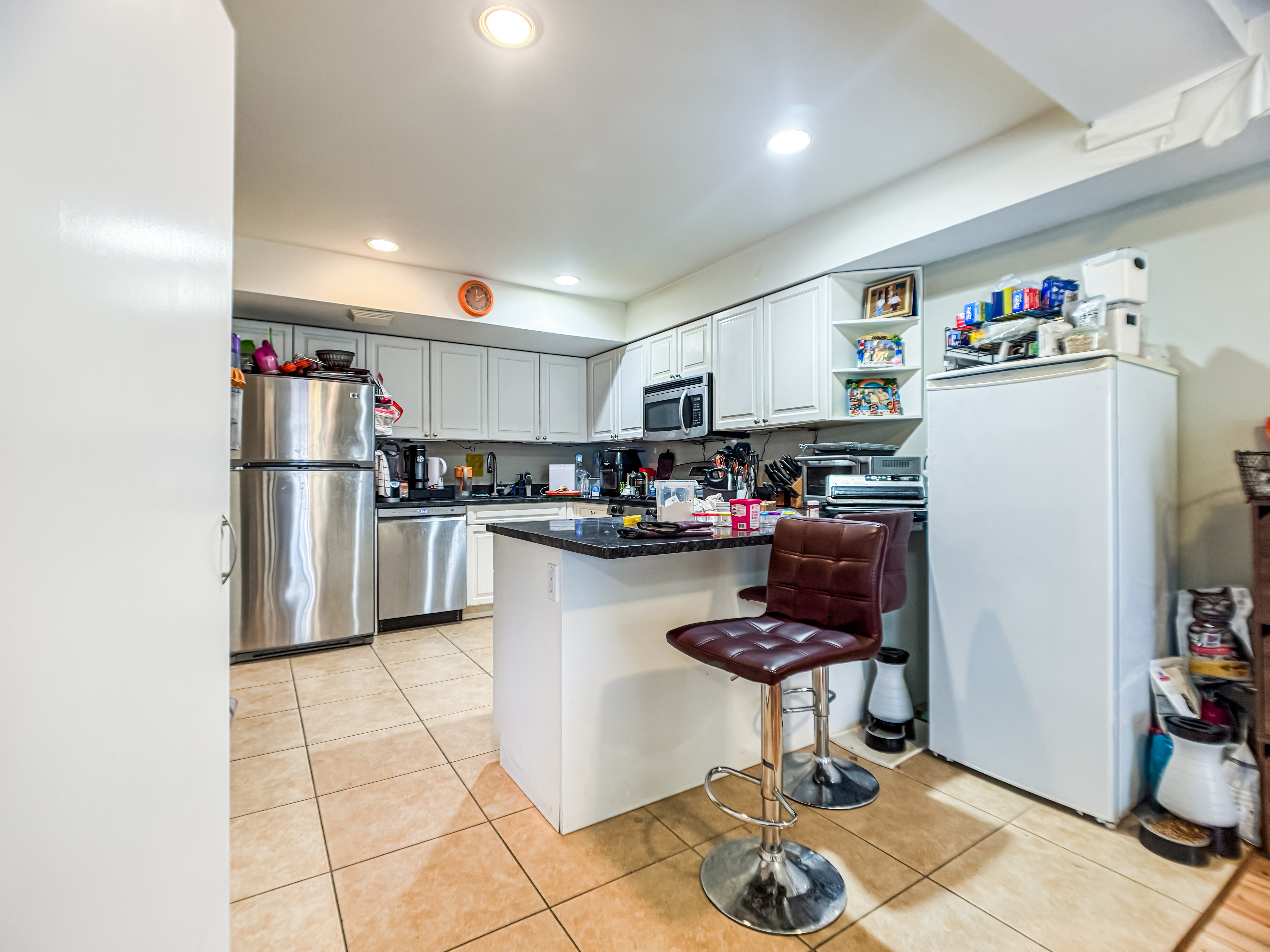 3827 28th Street Queens, NY 11101 - Photo 7 of 13 a kitchen with stainless steel appliances granite countertop a refrigerator and a stove top oven