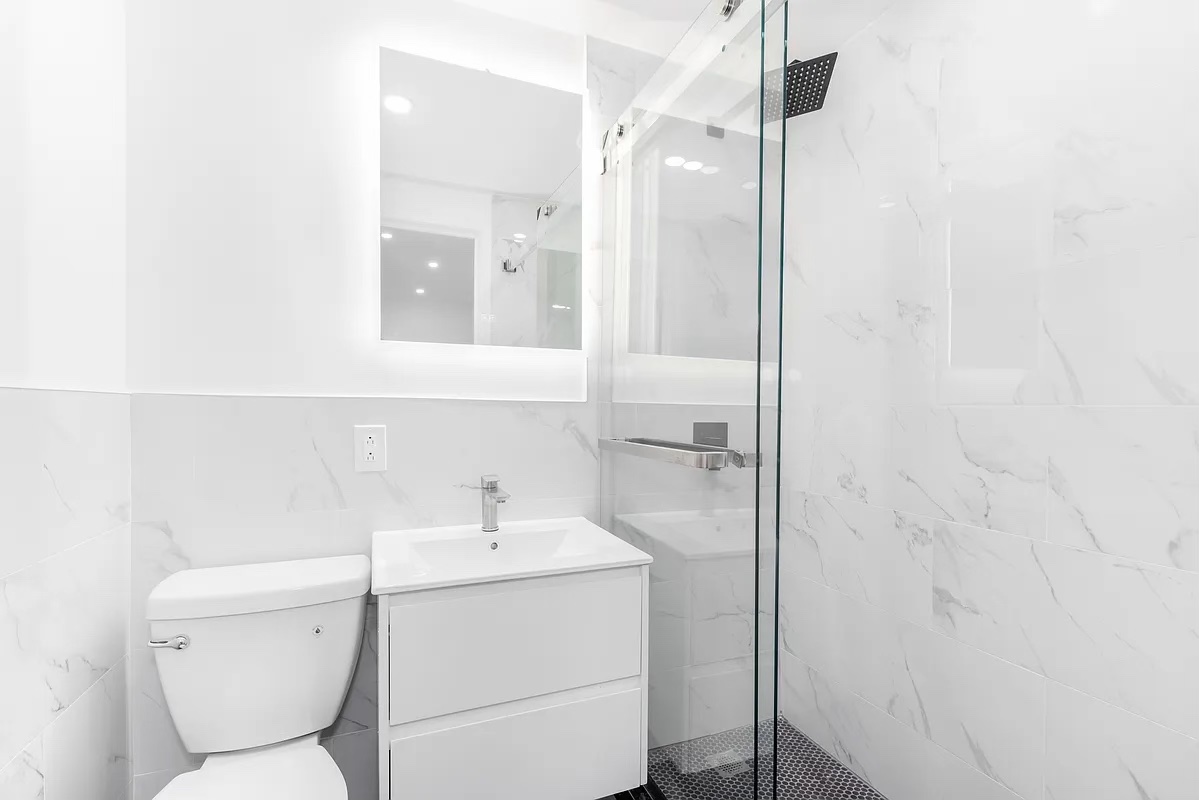 324 East 84th Street, Unit 1D Manhattan, NY 10028 - Photo 6 of 6 a bathroom with a toilet sink and shower