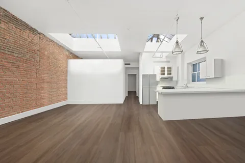 a view of a room with wooden floor and cabinet