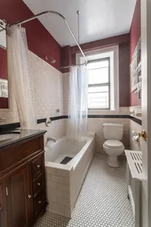 a bathroom with a sink a toilet and bathtub